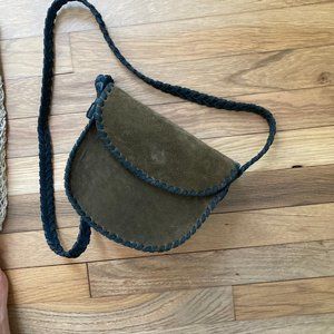 Green leather bag with black strap and silver detailed bottom